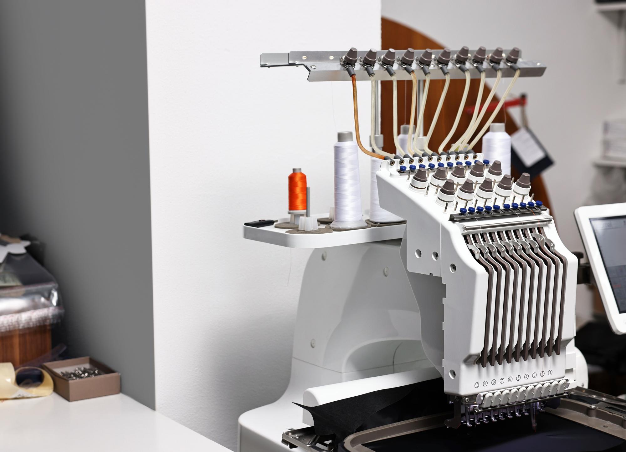 craft workspace with embroidery machines and samples
